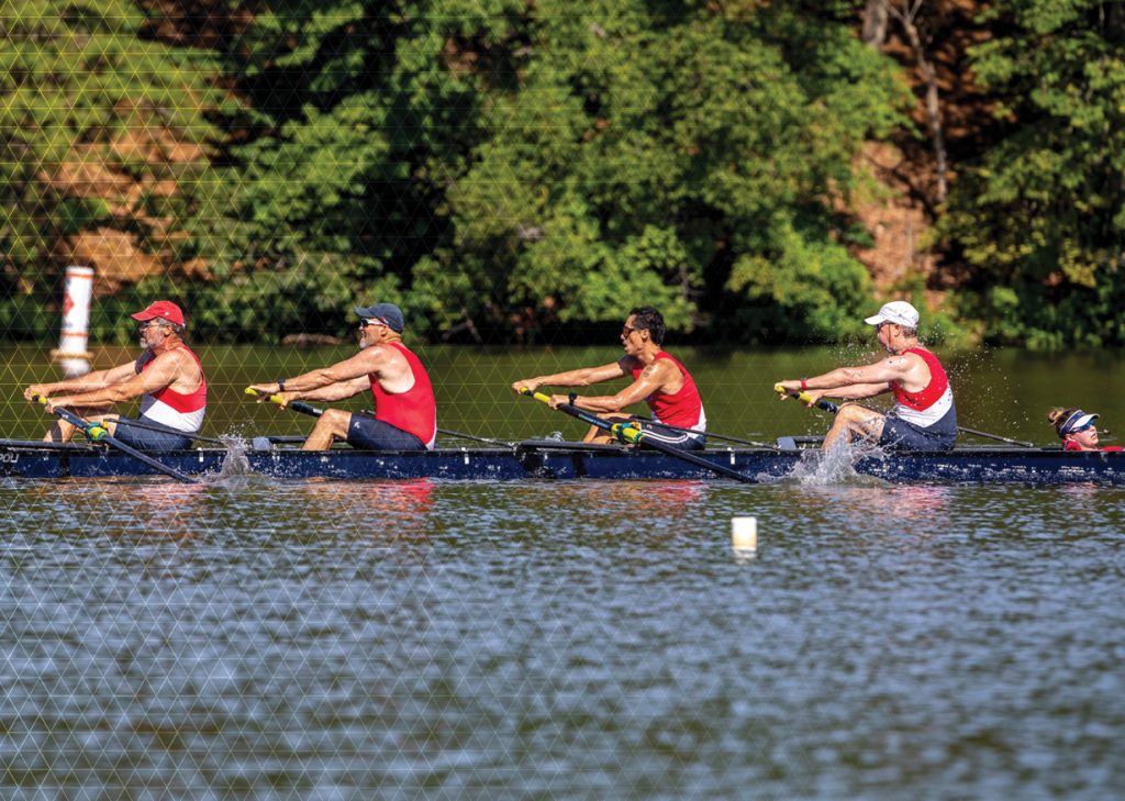 mens coxed four rowing boat with red shirts