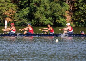 mens coxed four rowing boat with red shirts