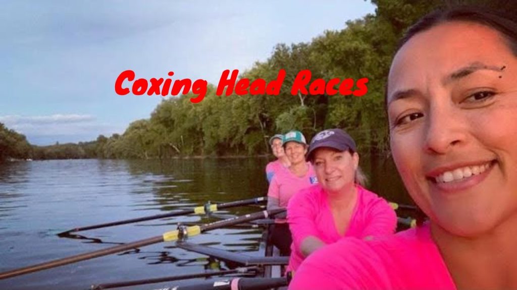three women in in a rowing boat wearing pink shirts