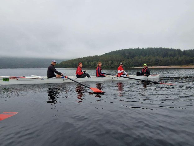 Coxed four masters rowing crew on Loch Ness.