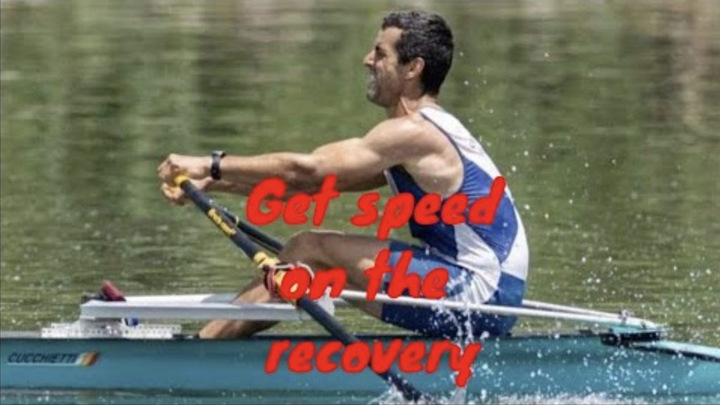 Man racing single scull rowing extended arms