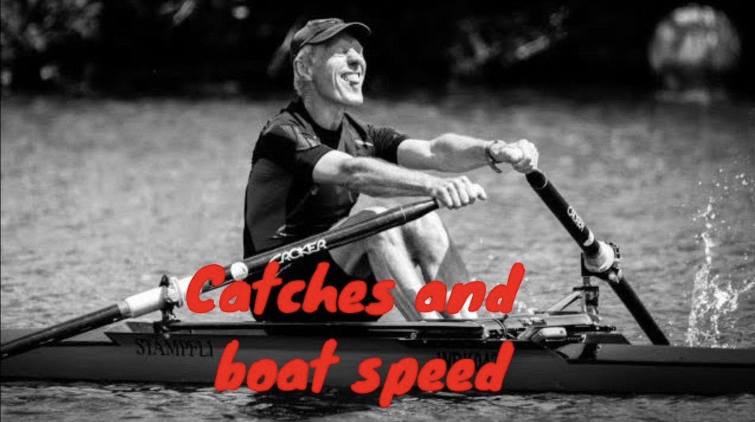 black and white photo of a smiling older man rowing a single scull at half slide