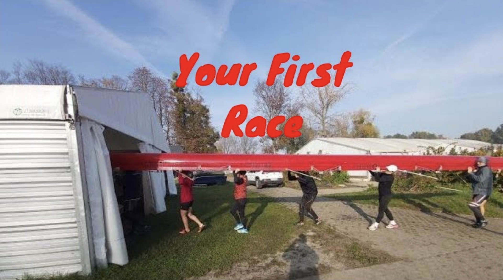 Rowers carry a red boat into the boat tent.