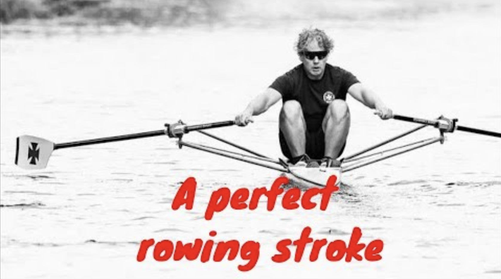 Man in a rowing boat at the catch wearing sun glasses