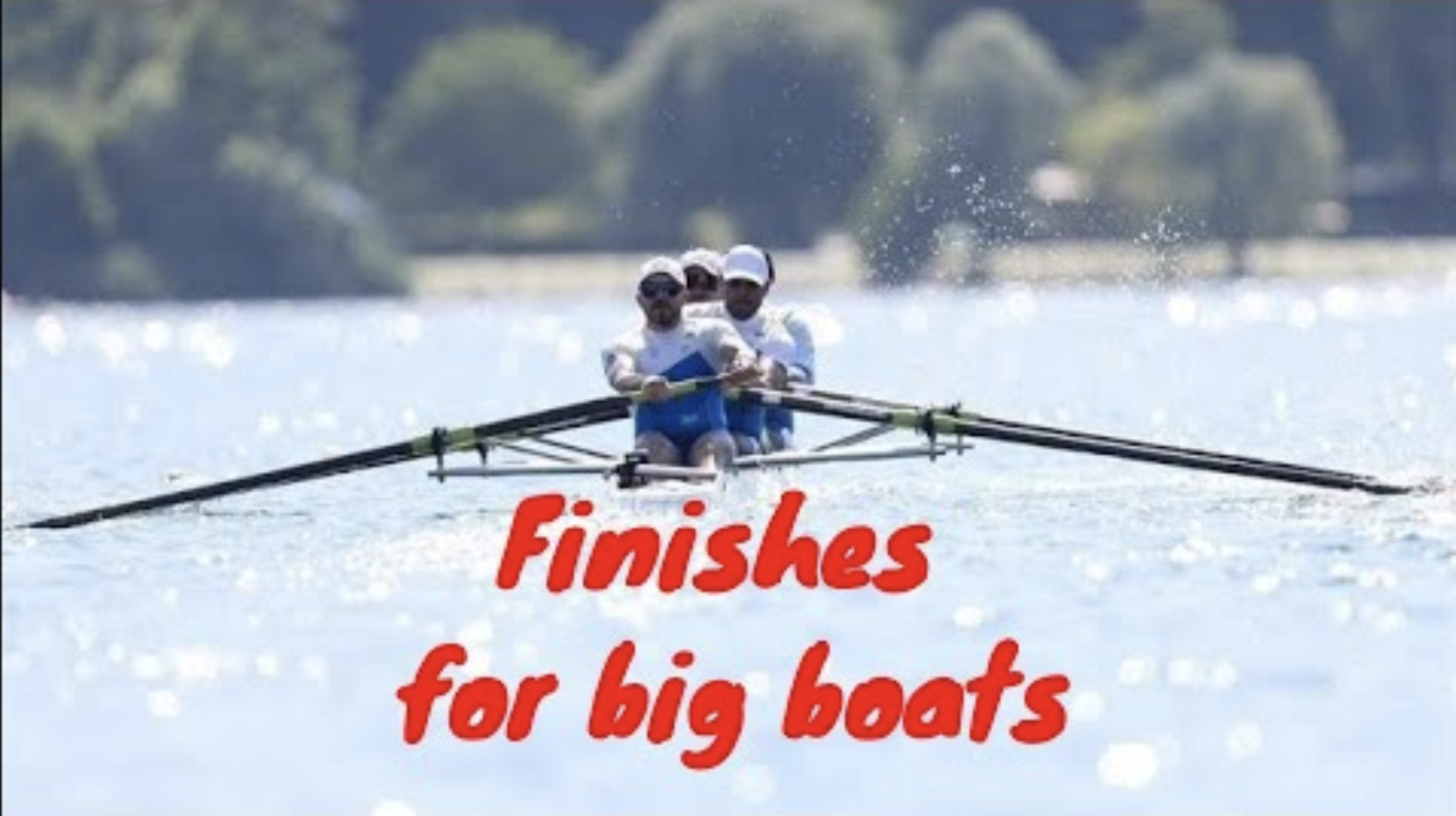 Rowing mens four racing on blue lake water
